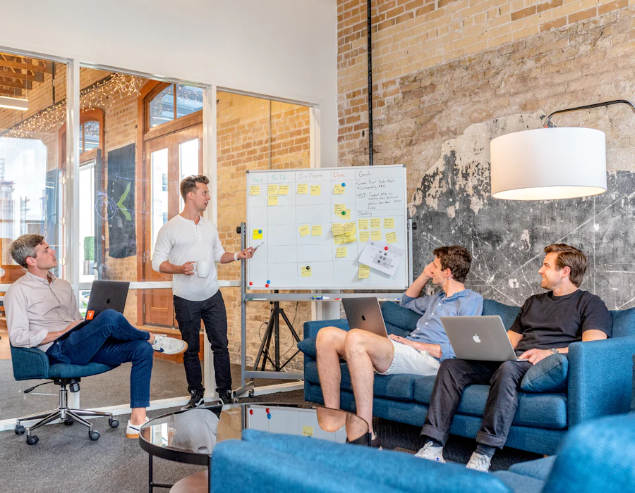 Small agency team planning client work at a whiteboard